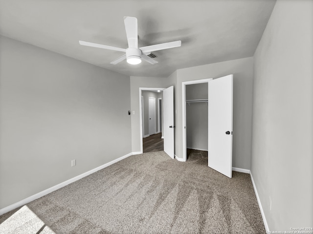 unfurnished bedroom featuring a closet, dark carpet, and ceiling fan