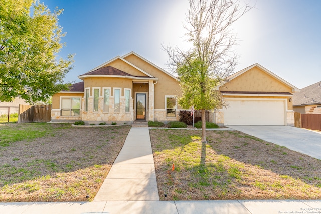 view of front of property featuring a front lawn and a garage