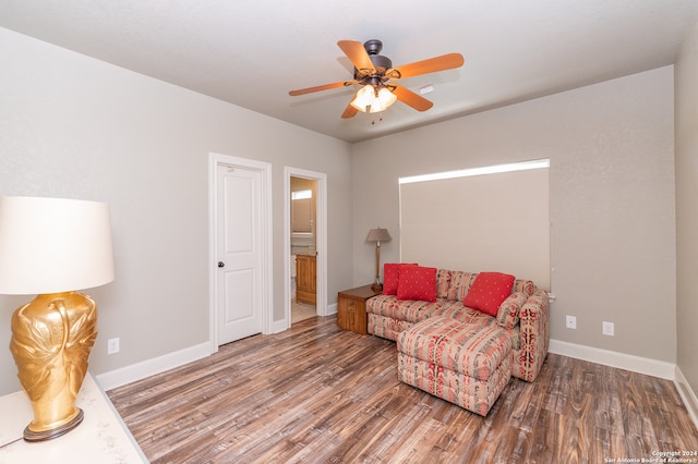 living area featuring ceiling fan and hardwood / wood-style flooring