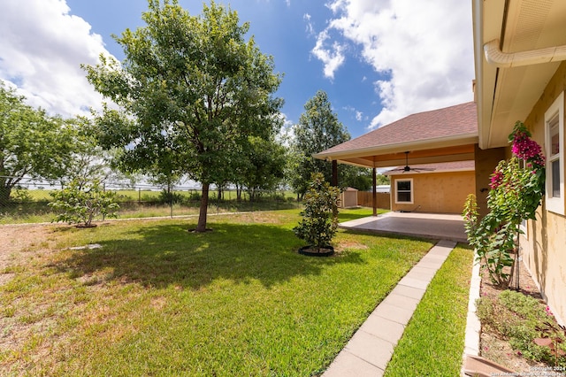 view of yard featuring a patio area and ceiling fan