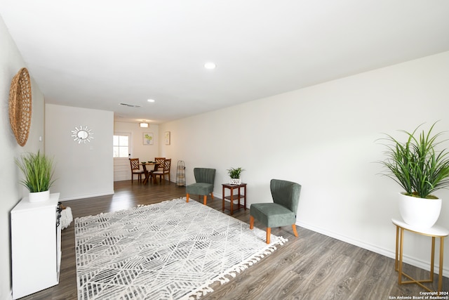 living room with dark hardwood / wood-style flooring