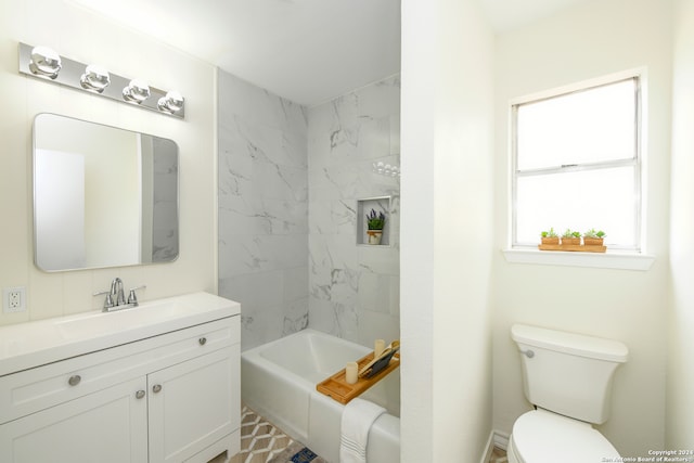 full bathroom featuring tile flooring, large vanity, toilet, and tiled shower / bath