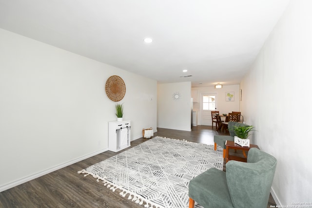 sitting room with dark wood-type flooring