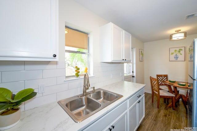 kitchen with sink, plenty of natural light, dark hardwood / wood-style floors, and white cabinets