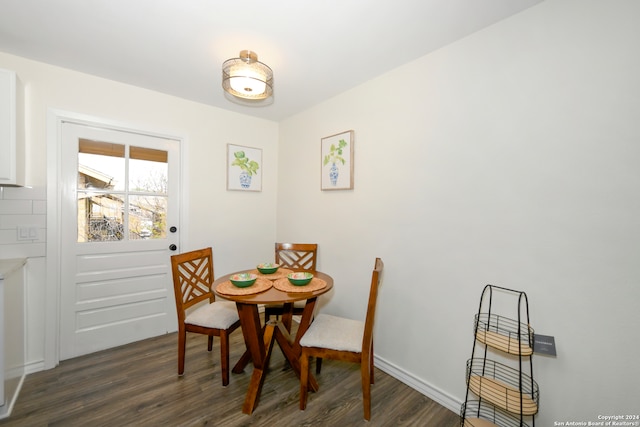 dining space with dark hardwood / wood-style floors