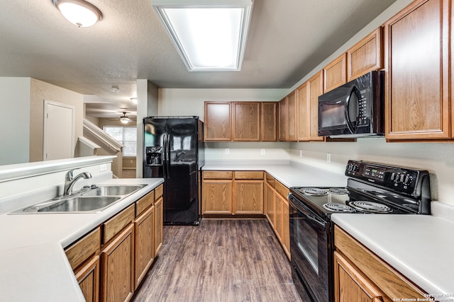 kitchen with dark hardwood / wood-style floors, black appliances, ceiling fan, a textured ceiling, and sink