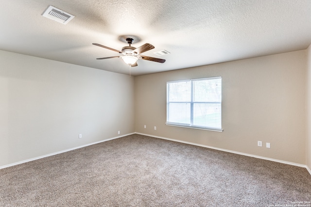 spare room with ceiling fan, carpet flooring, and a textured ceiling