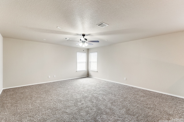 carpeted empty room with ceiling fan and a textured ceiling