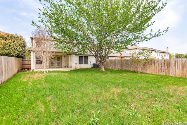 view of yard with central AC and a patio area