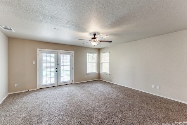 spare room with light carpet, a textured ceiling, ceiling fan, and french doors