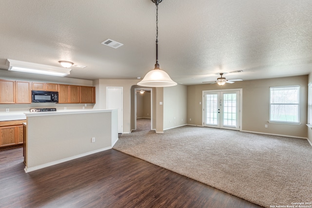 kitchen with french doors, ceiling fan, dark wood-type flooring, and pendant lighting