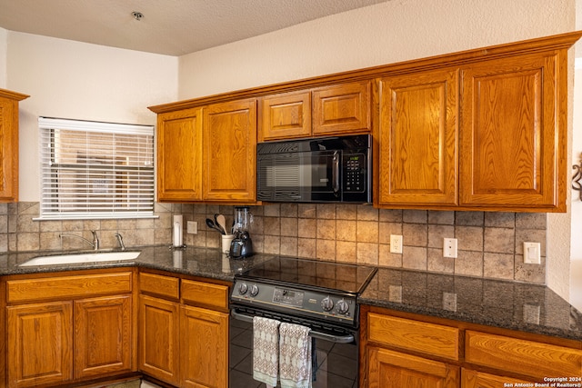 kitchen with black appliances, tile floors, sink, dark stone counters, and tasteful backsplash