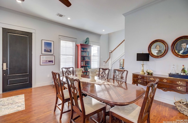 dining area with crown molding, light hardwood / wood-style floors, and ceiling fan