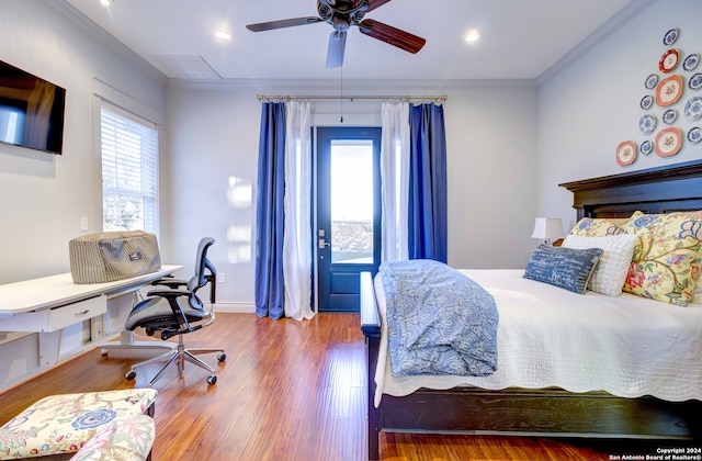 bedroom with crown molding, ceiling fan, and dark wood-type flooring