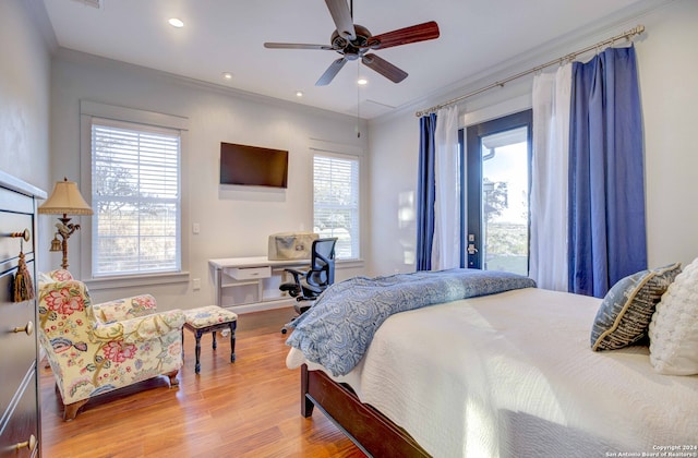 bedroom featuring ceiling fan, light wood-type flooring, ornamental molding, and multiple windows