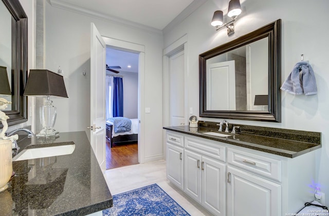 bathroom with crown molding, tile flooring, oversized vanity, and ceiling fan with notable chandelier