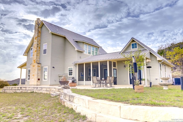 view of front of property featuring central AC, a front yard, and a patio