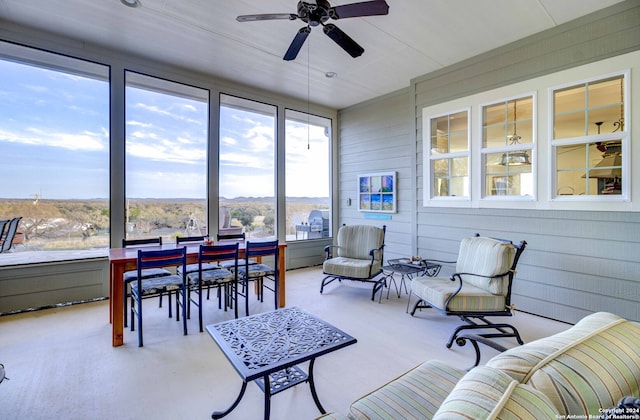 sunroom / solarium featuring ceiling fan