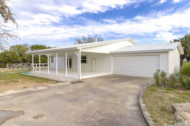 view of front of property featuring covered porch and a garage