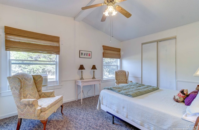 carpeted bedroom featuring vaulted ceiling with beams, multiple windows, a closet, and ceiling fan