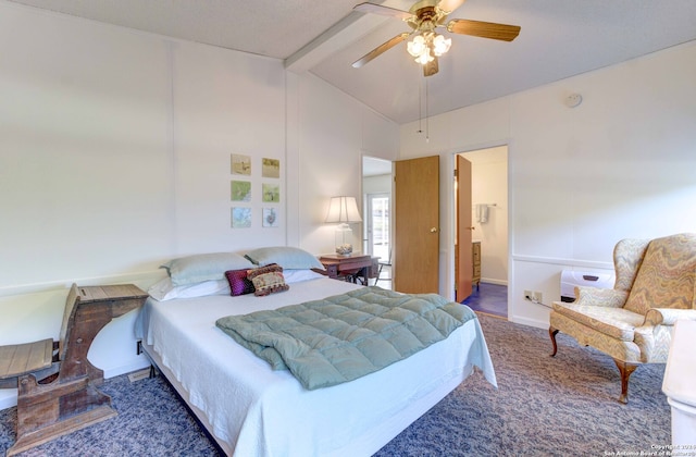 bedroom with beamed ceiling, high vaulted ceiling, dark colored carpet, ensuite bath, and ceiling fan