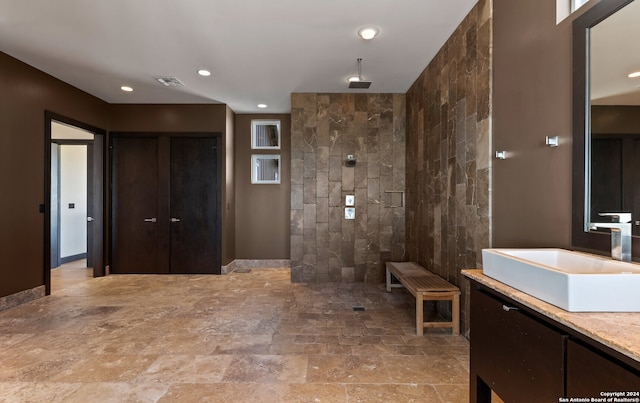 bathroom featuring vanity, tile flooring, and tile walls