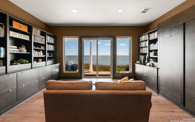 interior space featuring a water view and light hardwood / wood-style flooring