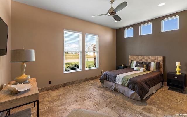 bedroom featuring light tile floors, multiple windows, and ceiling fan