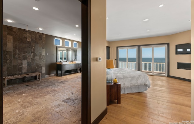 interior space featuring light hardwood / wood-style flooring and a water view