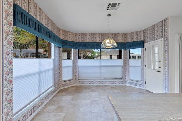 unfurnished dining area featuring light tile floors