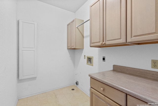 laundry room featuring light tile flooring, cabinets, hookup for an electric dryer, and hookup for a washing machine