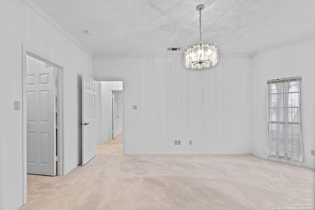 empty room with crown molding, a chandelier, and light colored carpet