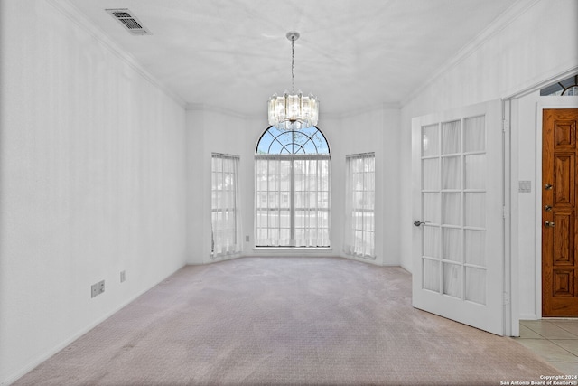 carpeted spare room with a chandelier and crown molding