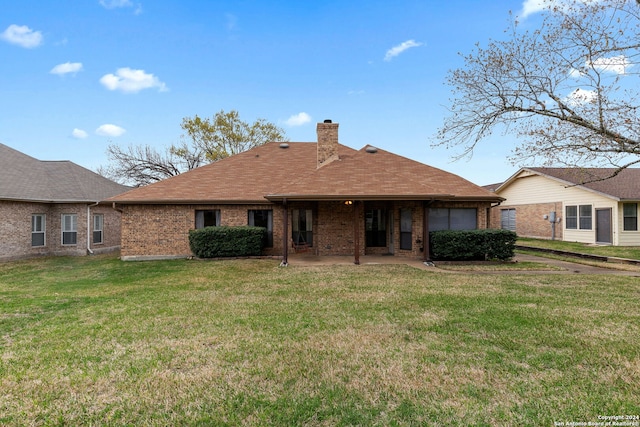 back of property featuring a lawn and a patio area