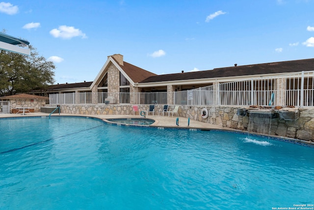 view of pool featuring pool water feature and a patio area