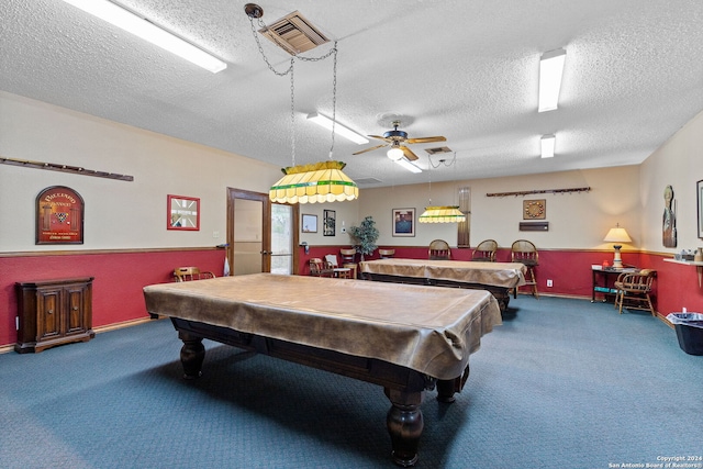 recreation room featuring a textured ceiling, billiards, dark carpet, and ceiling fan