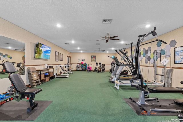 exercise area featuring ceiling fan, a textured ceiling, and carpet flooring