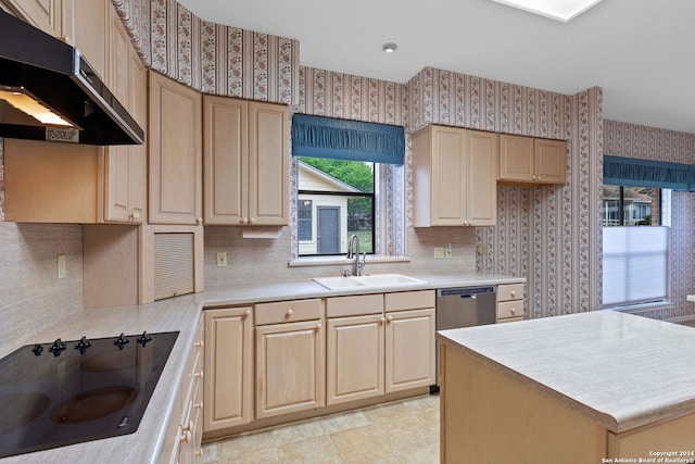 kitchen with cooktop, backsplash, sink, and light tile flooring