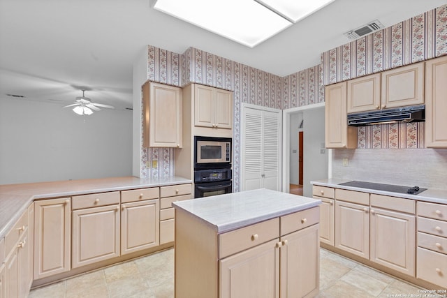 kitchen featuring black appliances, ceiling fan, light tile floors, a kitchen island, and tasteful backsplash