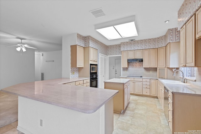 kitchen with black appliances, ceiling fan, a center island, and light tile floors