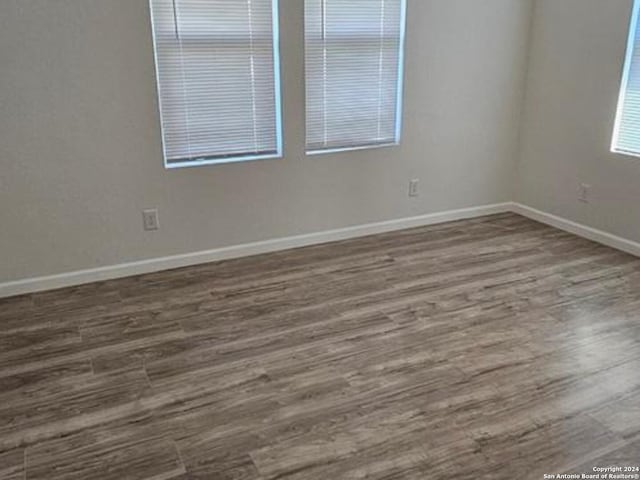 empty room with dark hardwood / wood-style floors