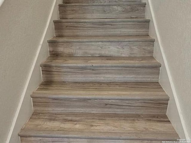 stairs with wood-type flooring