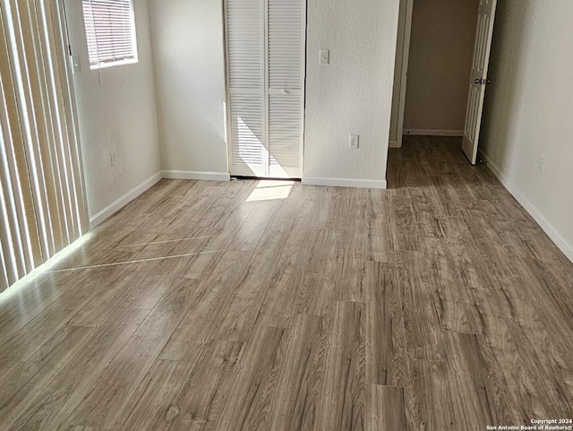 unfurnished bedroom with hardwood / wood-style flooring