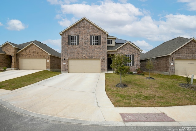 view of property featuring a front lawn and a garage