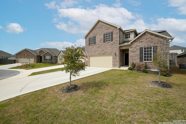 view of front of home featuring central AC, a front yard, and a garage