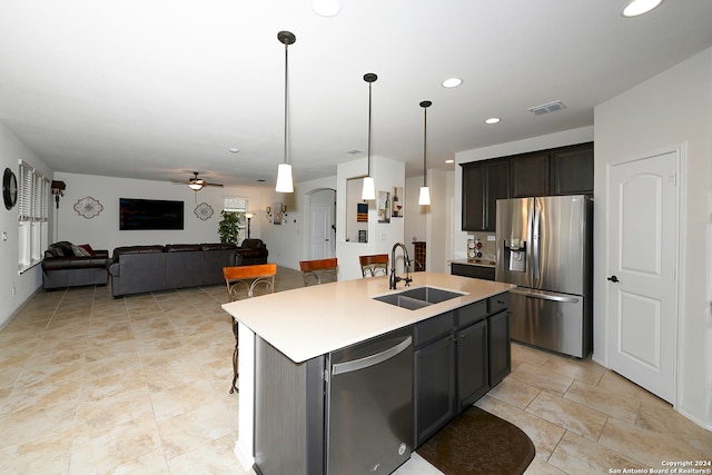 kitchen featuring appliances with stainless steel finishes, an island with sink, ceiling fan, and sink