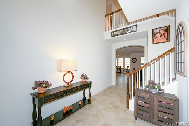 tiled entryway featuring a high ceiling