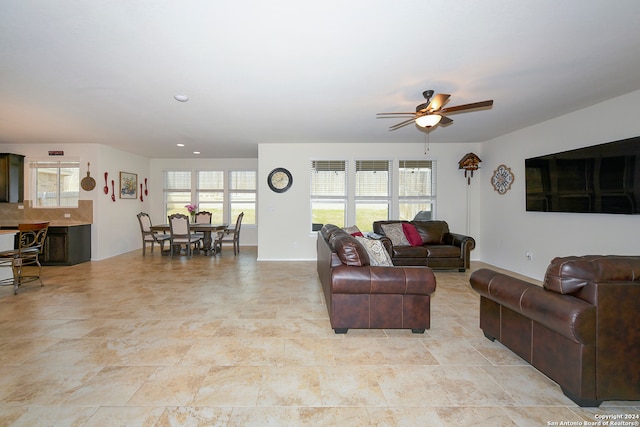 tiled living room with ceiling fan