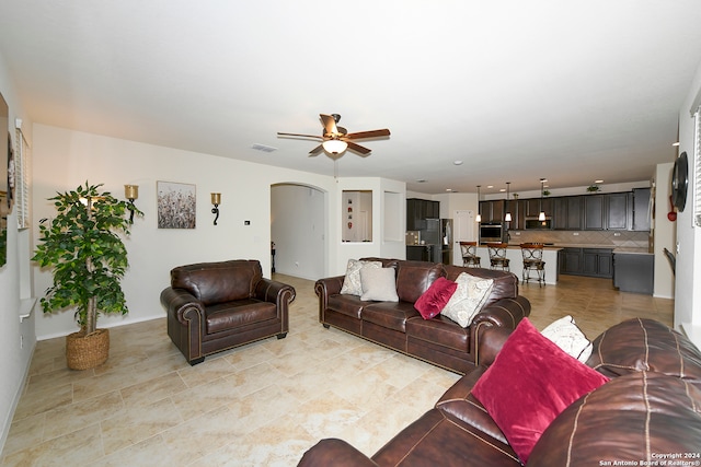 tiled living room with ceiling fan