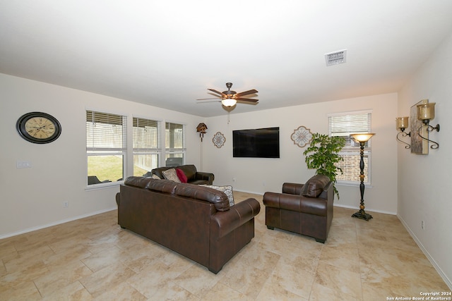 tiled living room with ceiling fan